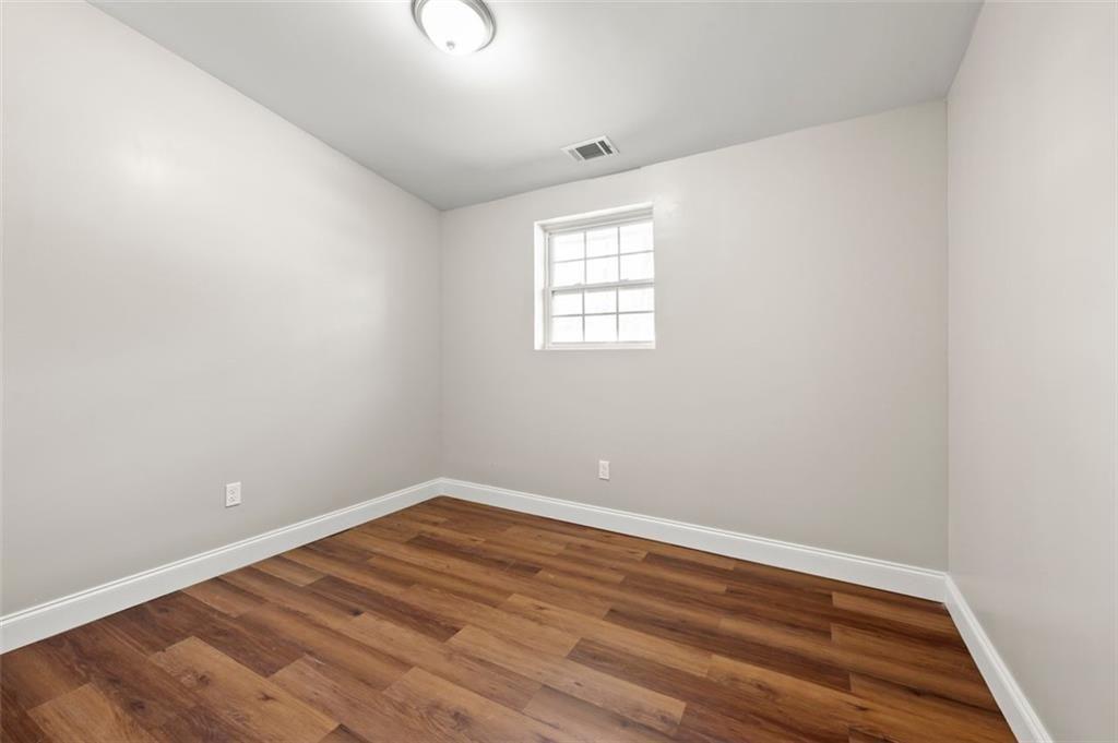 3480 Hogan Road Southwest Atlanta, GA 30331 - Photo 18 of 25 an empty room with wooden floor and windows