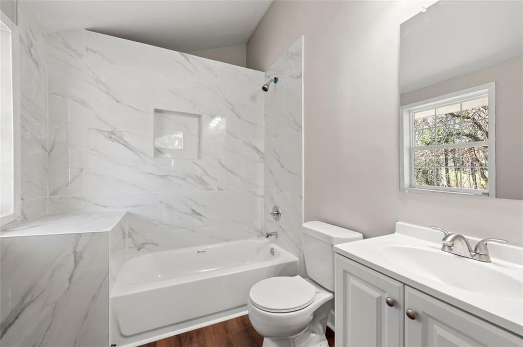 3480 Hogan Road Southwest Atlanta, GA 30331 - Photo 19 of 25 a bathroom with a sink a toilet and a bathtub