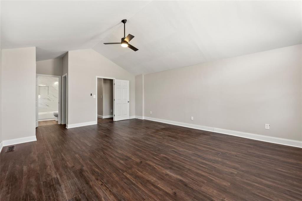 3480 Hogan Road Southwest Atlanta, GA 30331 - Photo 20 of 25 a view of an empty room with wooden floor and chandelier