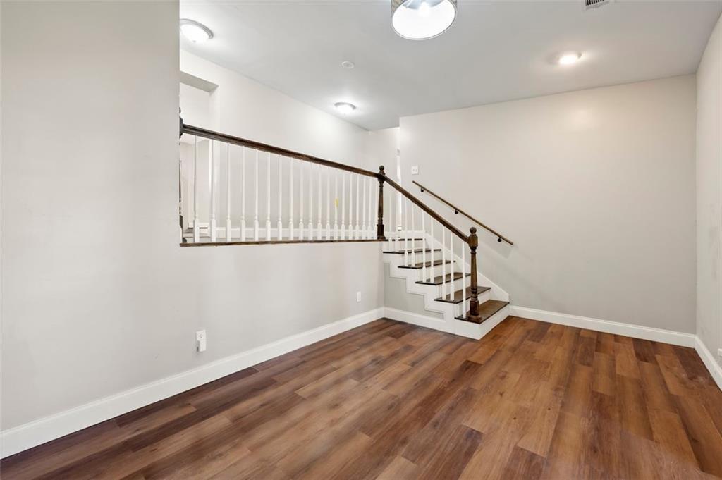 3480 Hogan Road Southwest Atlanta, GA 30331 - Photo 2 of 25 a view of an empty room with wooden floor and stairs