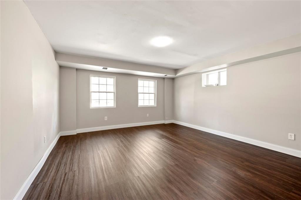 3480 Hogan Road Southwest Atlanta, GA 30331 - Photo 22 of 25 an empty room with wooden floor and windows