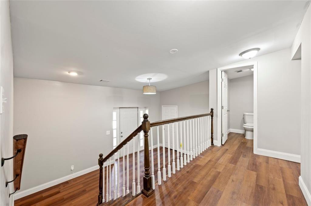 3480 Hogan Road Southwest Atlanta, GA 30331 - Photo 3 of 25 a view of a hallway with wooden floor and staircase