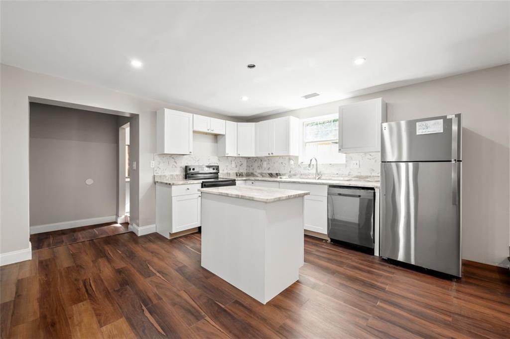 3480 Hogan Road Southwest Atlanta, GA 30331 - Photo 5 of 25 a kitchen with a refrigerator a sink and a stove top oven