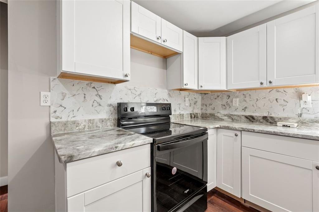 3480 Hogan Road Southwest Atlanta, GA 30331 - Photo 7 of 25 a kitchen with granite countertop white cabinets and white appliances