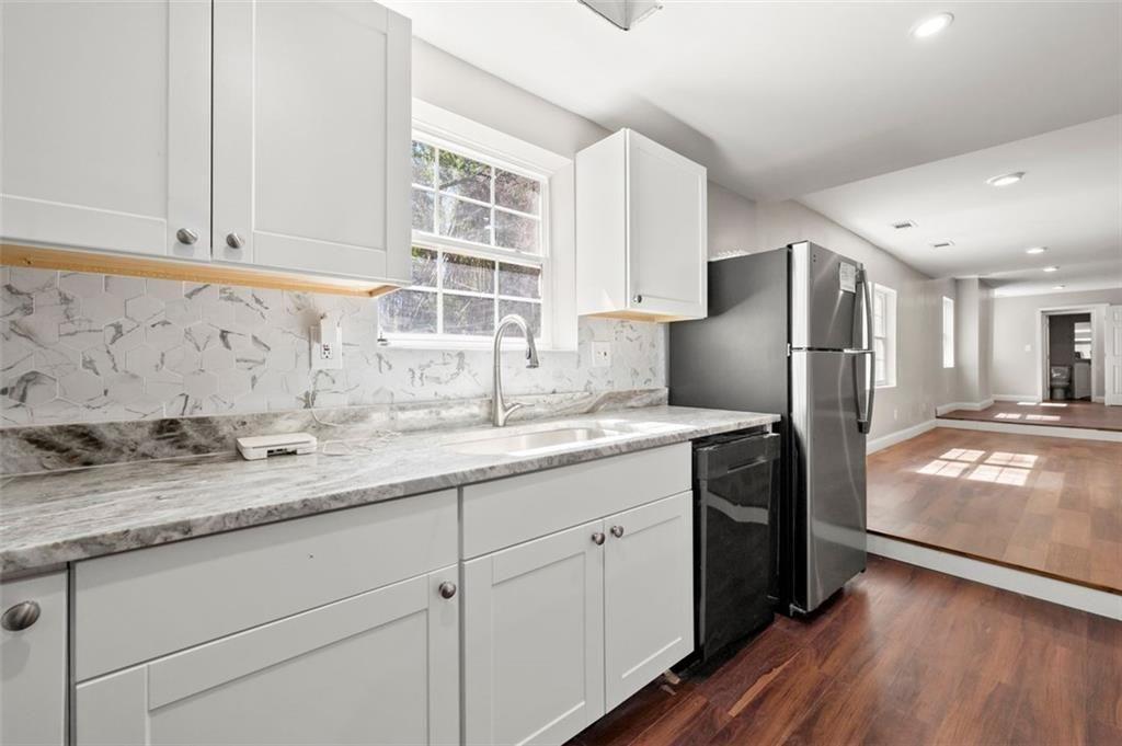 3480 Hogan Road Southwest Atlanta, GA 30331 - Photo 8 of 25 a kitchen with stainless steel appliances granite countertop a refrigerator and a sink