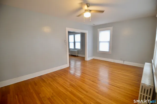 wooden floor in an empty room with a window