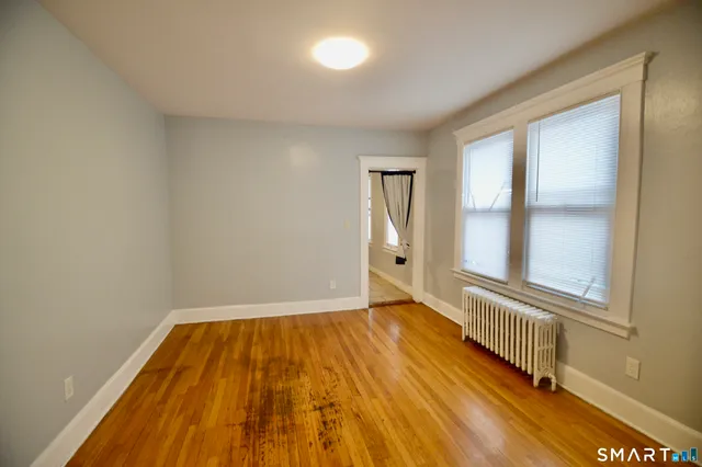 a view of a room with wooden floor and windows