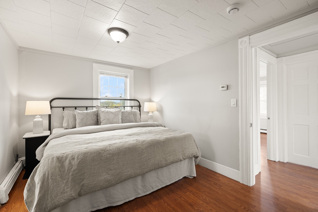 93 Bay State Road Methuen, MA 01844 - Photo 11 of 23 a bedroom with a bed and wooden floor