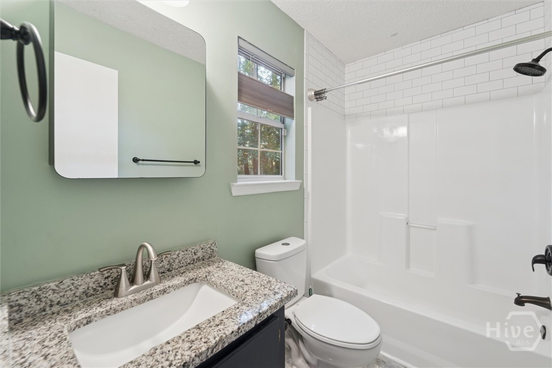 7206 Garfield Street Savannah, GA 31406 - Photo 19 of 30 Primary suite bath with combo shower/tub and granite countertop