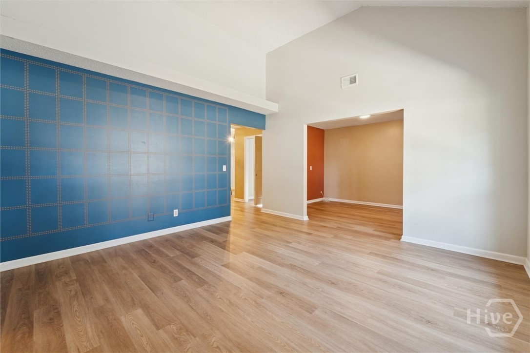7206 Garfield Street Savannah, GA 31406 - Photo 7 of 29 Living Room leading to family/bonus room, laundry room, and kitchen