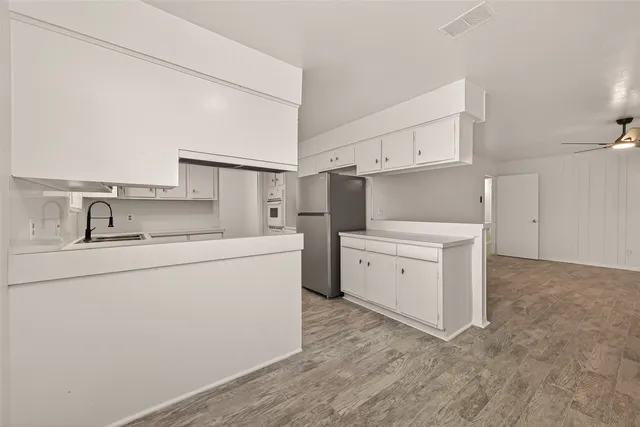 a utility room with cabinets washer and dryer