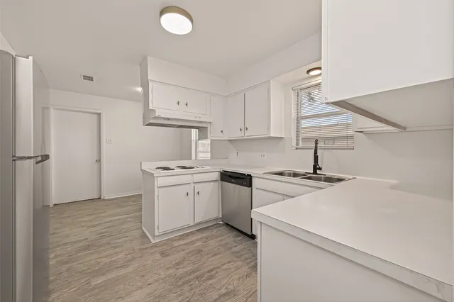 a kitchen with a stove a sink and a refrigerator