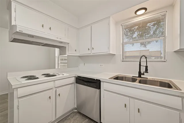 a kitchen with white cabinets and white appliances