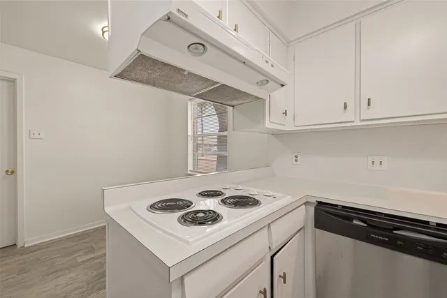 a white stove top oven sitting inside of a kitchen