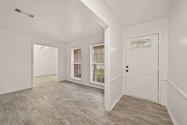 wooden floor with white walls