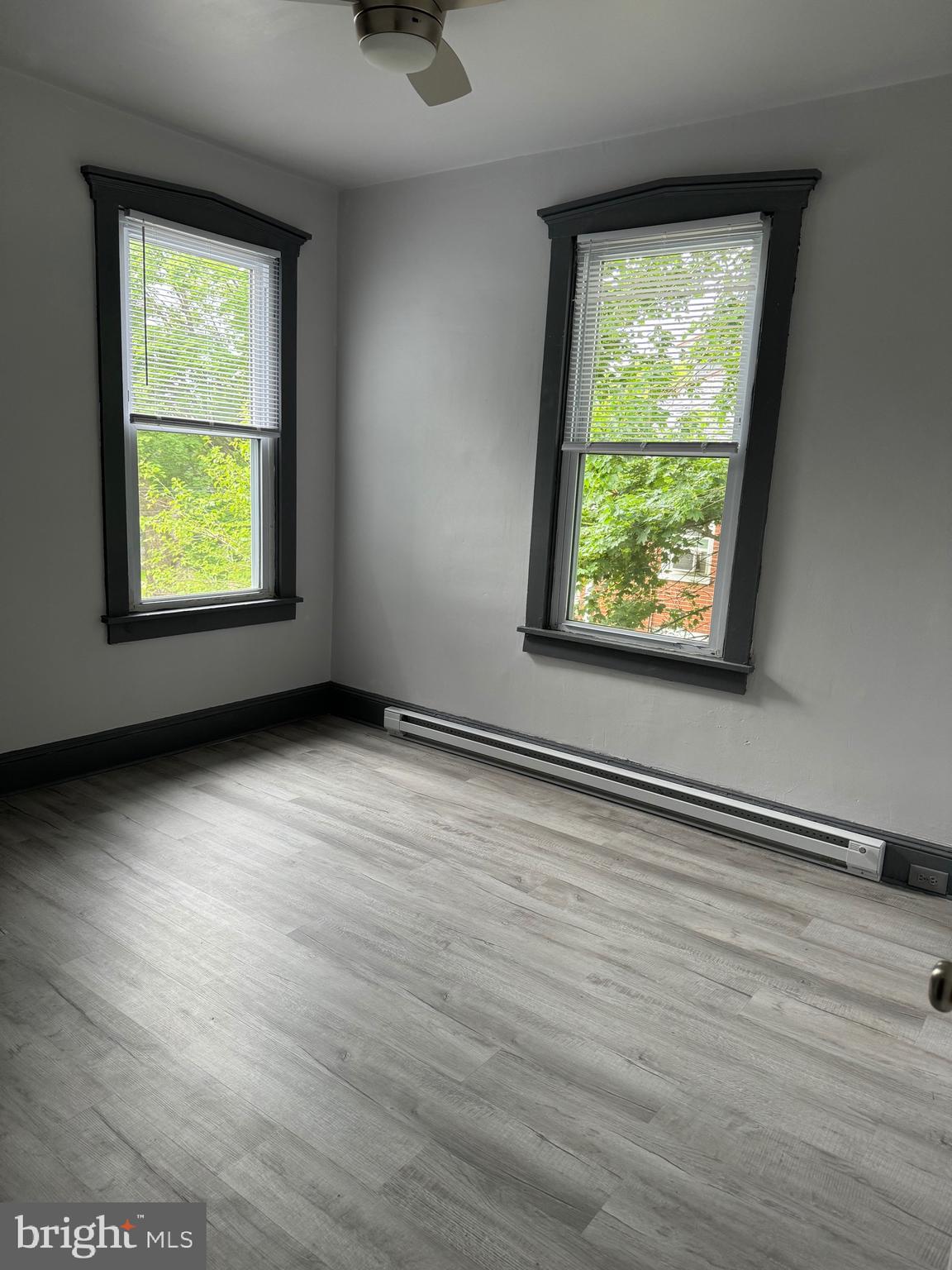 108 West State Street, Unit B Quarryville, PA 17566 - Photo 3 of 4 an empty room with wooden floor and windows
