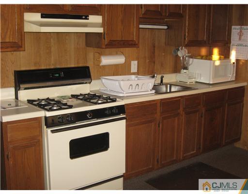 122 Winthrop Road Edison, NJ 08817 - Photo 4 of 14 a kitchen with granite countertop a stove and a sink