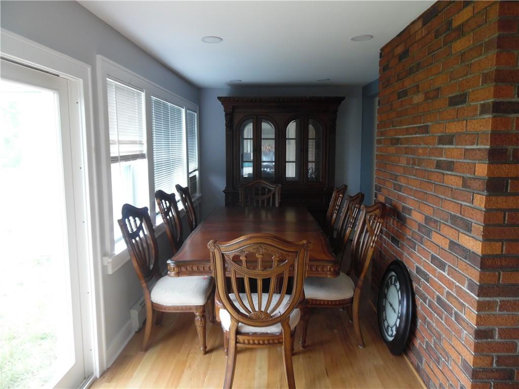 105 Dr Duggan Road Bethel, NY 12720 - Photo 17 of 29 Dining area featuring brick wall and hardwood / wood-style flooring