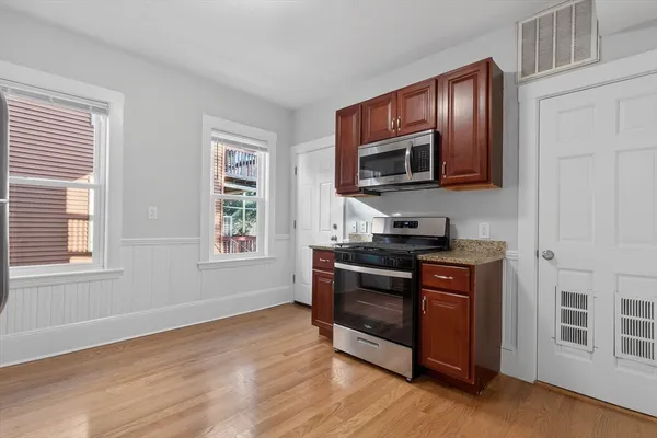 a kitchen with stainless steel appliances granite countertop a stove microwave and sink