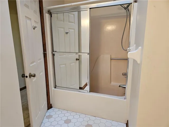 a bathroom with a glass shower door
