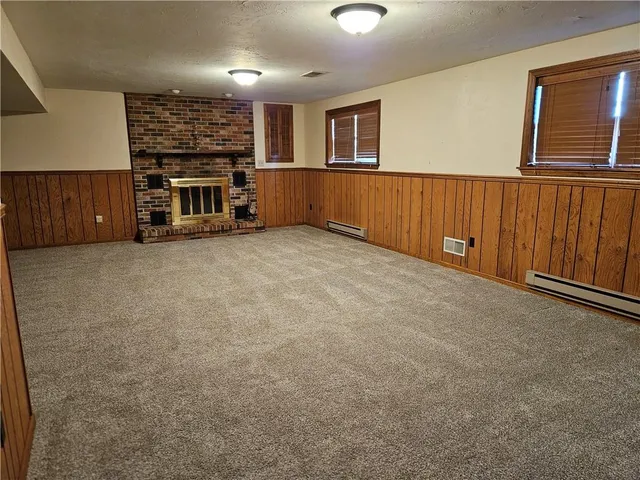 a view of an empty room with a fireplace