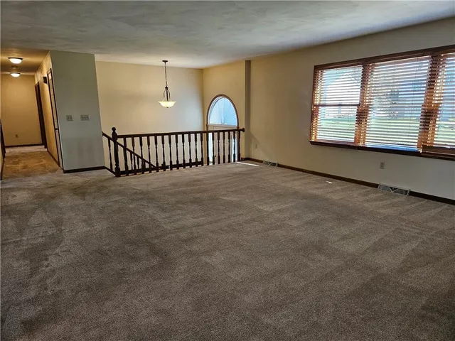 a view of an empty room with windows