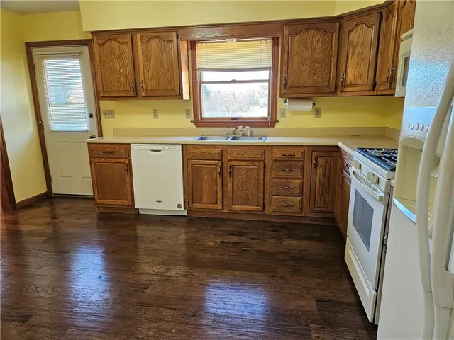 a kitchen with granite countertop a sink and a stove top oven