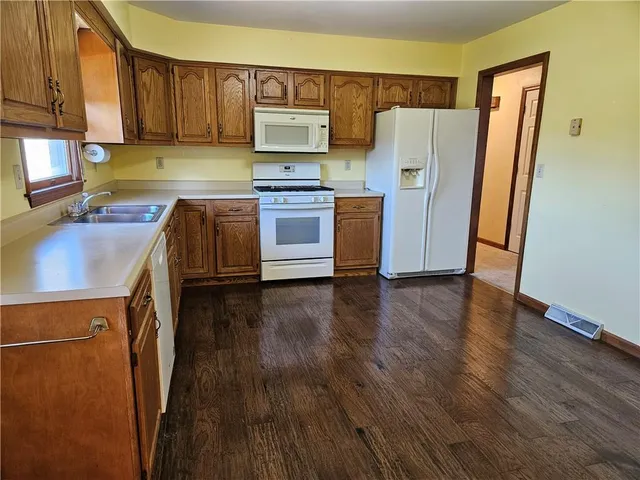 a kitchen with stainless steel appliances a refrigerator stove and sink