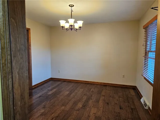 a view of wooden floor and chandelier in a room