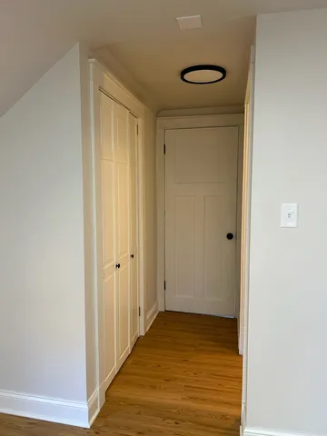 a view of hallway with wooden floor