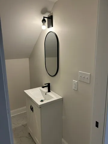 a bathroom with a tub sink and mirror