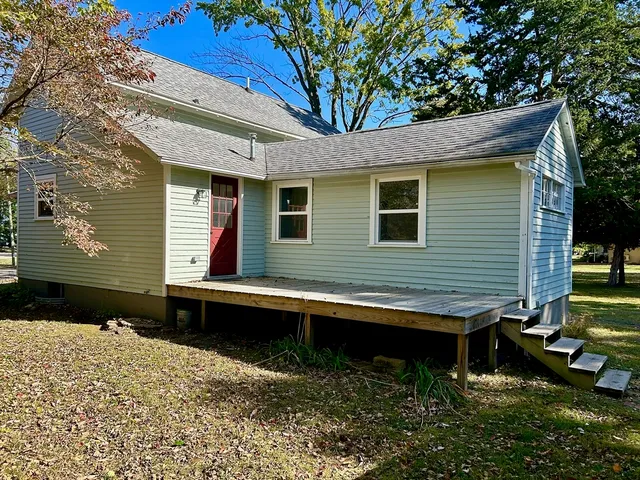 a view of an entryway with wooden floor and staircase