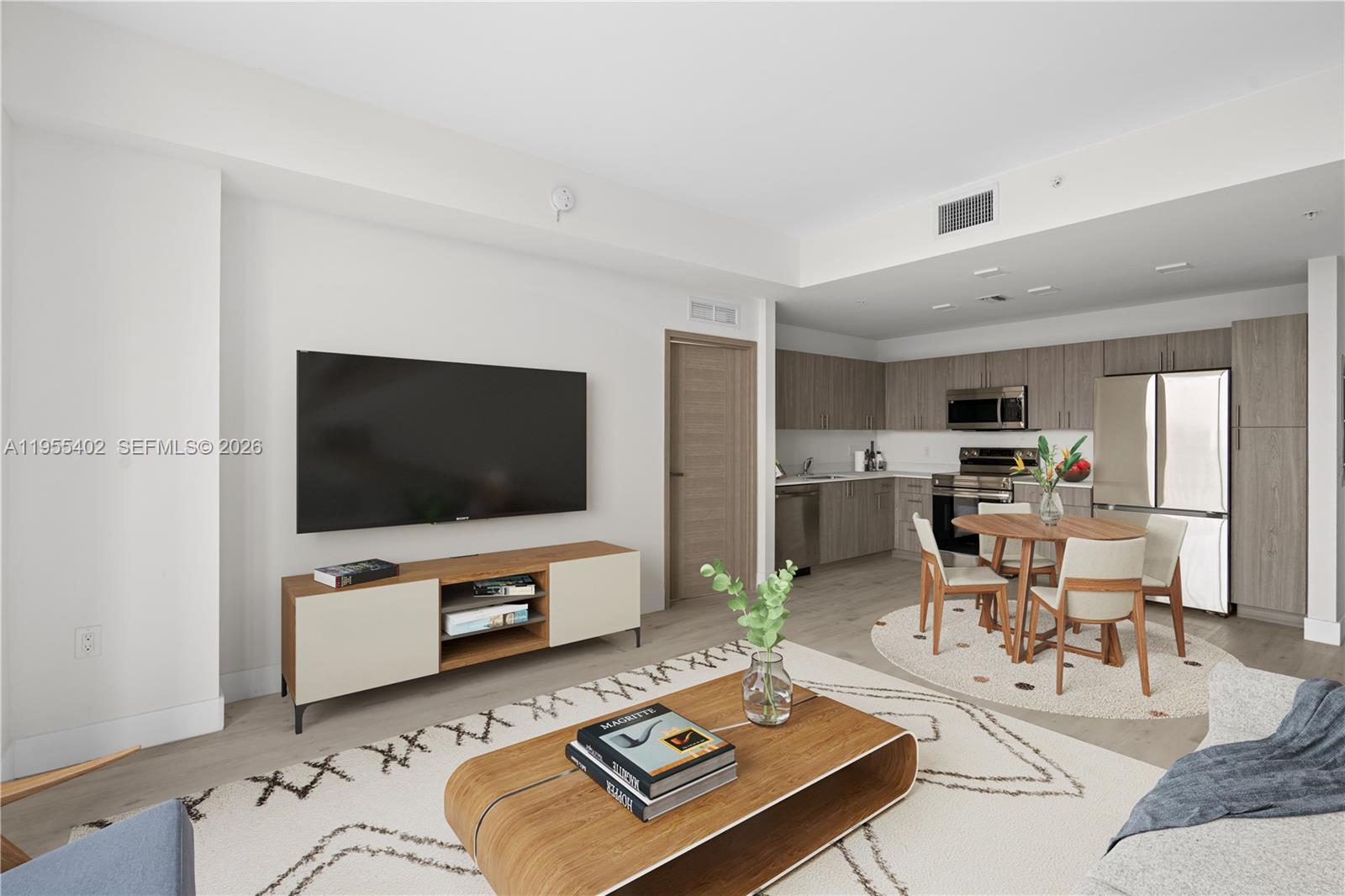 1601 Southwest 32nd Avenue, Unit 513 Miami, FL 33145 - Photo 2 of 6 a living room with furniture and a flat screen tv