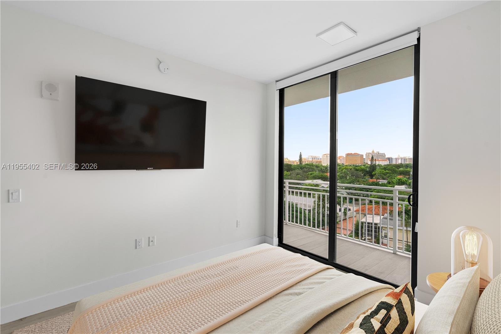 1601 Southwest 32nd Avenue, Unit 513 Miami, FL 33145 - Photo 6 of 6 a bedroom with a bed and a flat screen tv