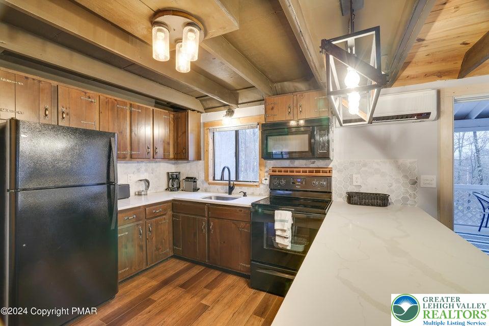 3176 Cherry Ridge Road Bushkill, PA 18324 - Photo 11 of 37 a kitchen with stainless steel appliances granite countertop a sink a stove and refrigerator