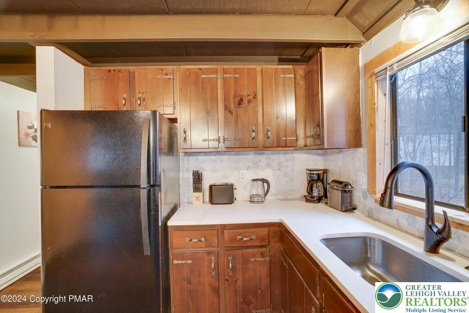 3176 Cherry Ridge Road Bushkill, PA 18324 - Photo 12 of 37 a kitchen with refrigerator and cabinets