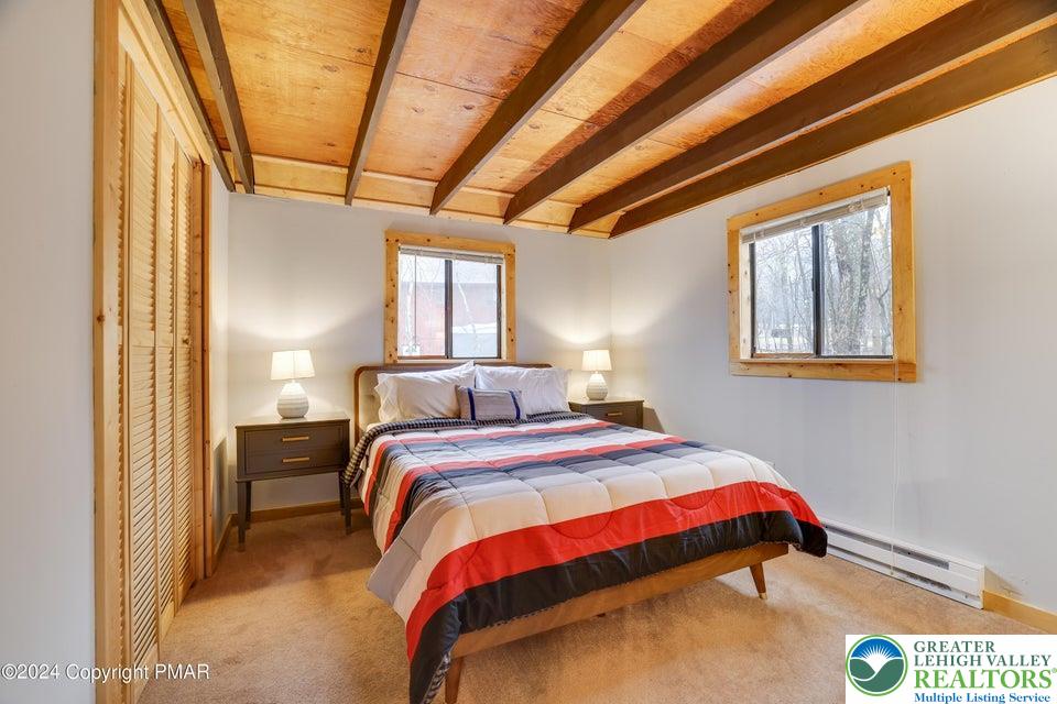 3176 Cherry Ridge Road Bushkill, PA 18324 - Photo 20 of 37 a bedroom with a bed and a chandelier