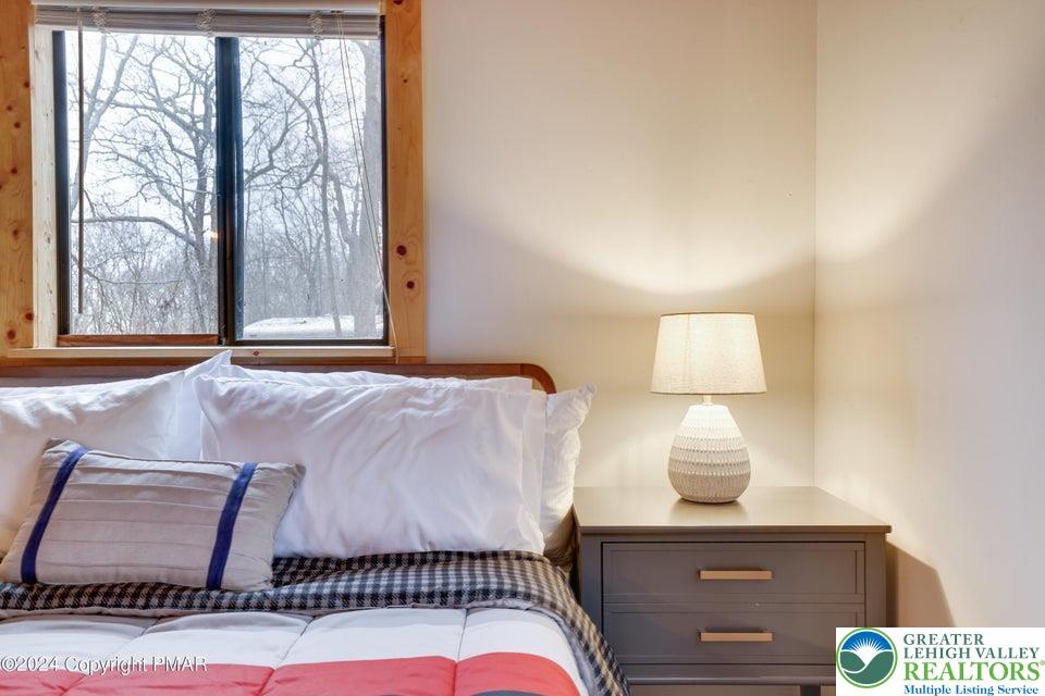 3176 Cherry Ridge Road Bushkill, PA 18324 - Photo 21 of 37 a bedroom with a bed and a night stand