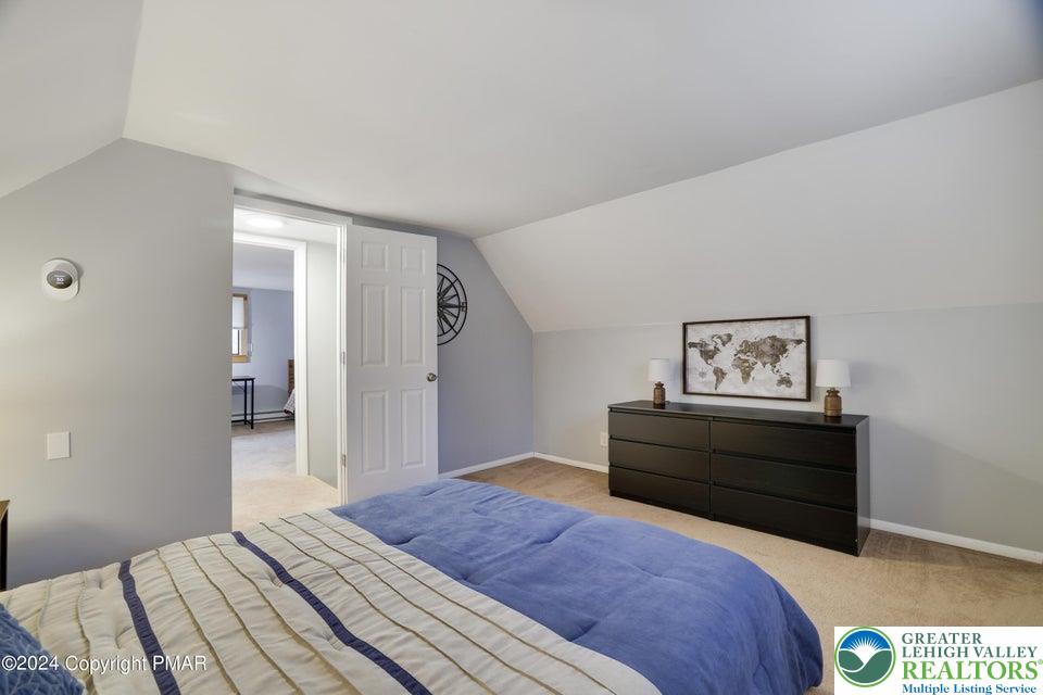 3176 Cherry Ridge Road Bushkill, PA 18324 - Photo 23 of 37 a bedroom with a bed and painting on the wall