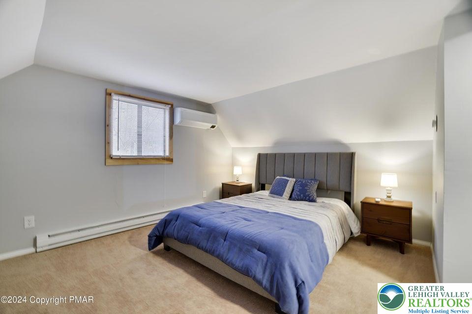 3176 Cherry Ridge Road Bushkill, PA 18324 - Photo 24 of 37 a bedroom with a bed and a night stand