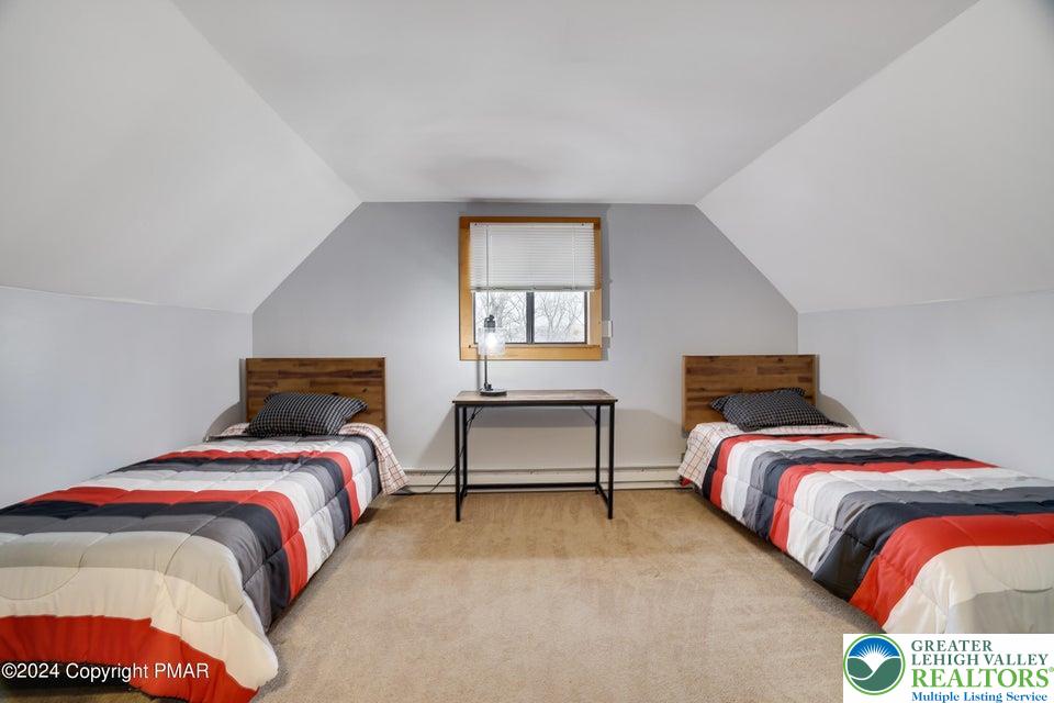 3176 Cherry Ridge Road Bushkill, PA 18324 - Photo 27 of 37 a bedroom with a bed and window