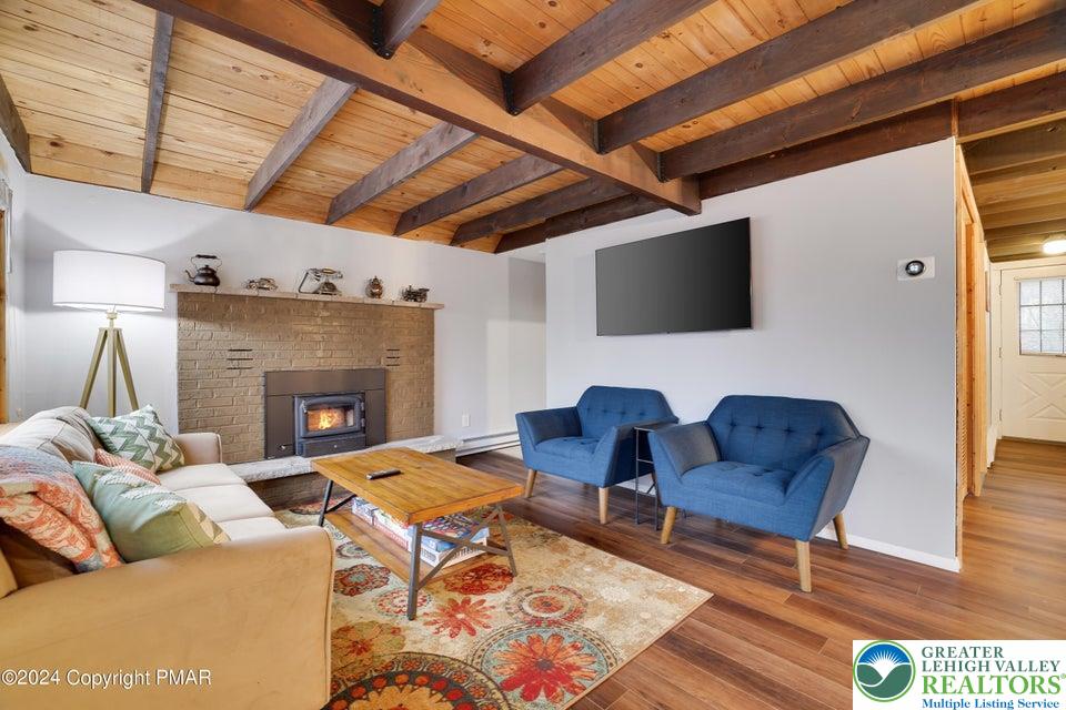 3176 Cherry Ridge Road Bushkill, PA 18324 - Photo 6 of 37 a living room with furniture and a fireplace