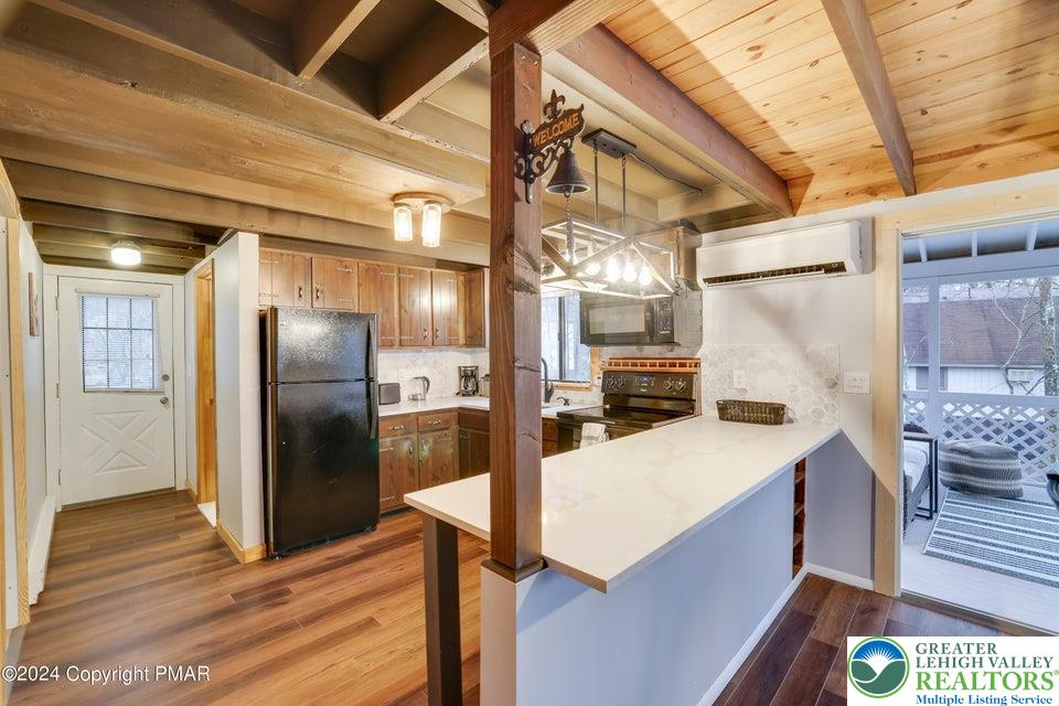 3176 Cherry Ridge Road Bushkill, PA 18324 - Photo 8 of 37 a kitchen with stainless steel appliances kitchen island granite countertop a refrigerator and a stove
