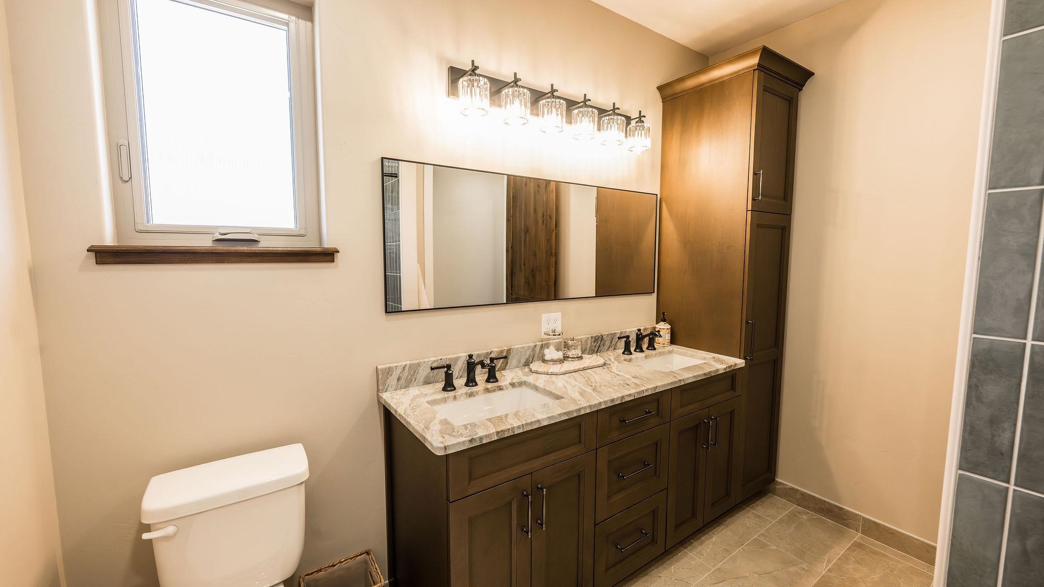 2639 Emerald Ridge Lane Grand Junction, CO 81506 - Photo 28 of 42 a bathroom with a toilet sink and mirror
