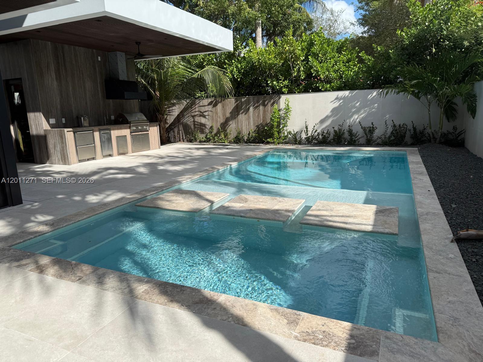 125 Southwest 29th Road Miami, FL 33129 - Photo 19 of 45 a view of backyard with a table and chairs under an umbrella