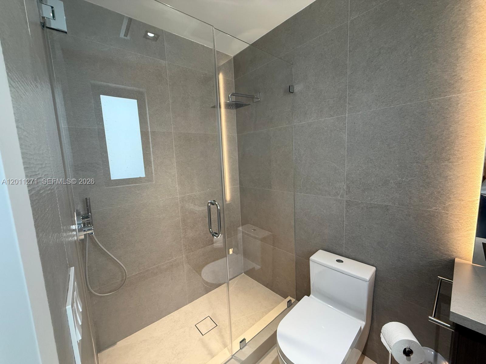 125 Southwest 29th Road Miami, FL 33129 - Photo 39 of 45 a white toilet sitting next to a bath tub and a shower