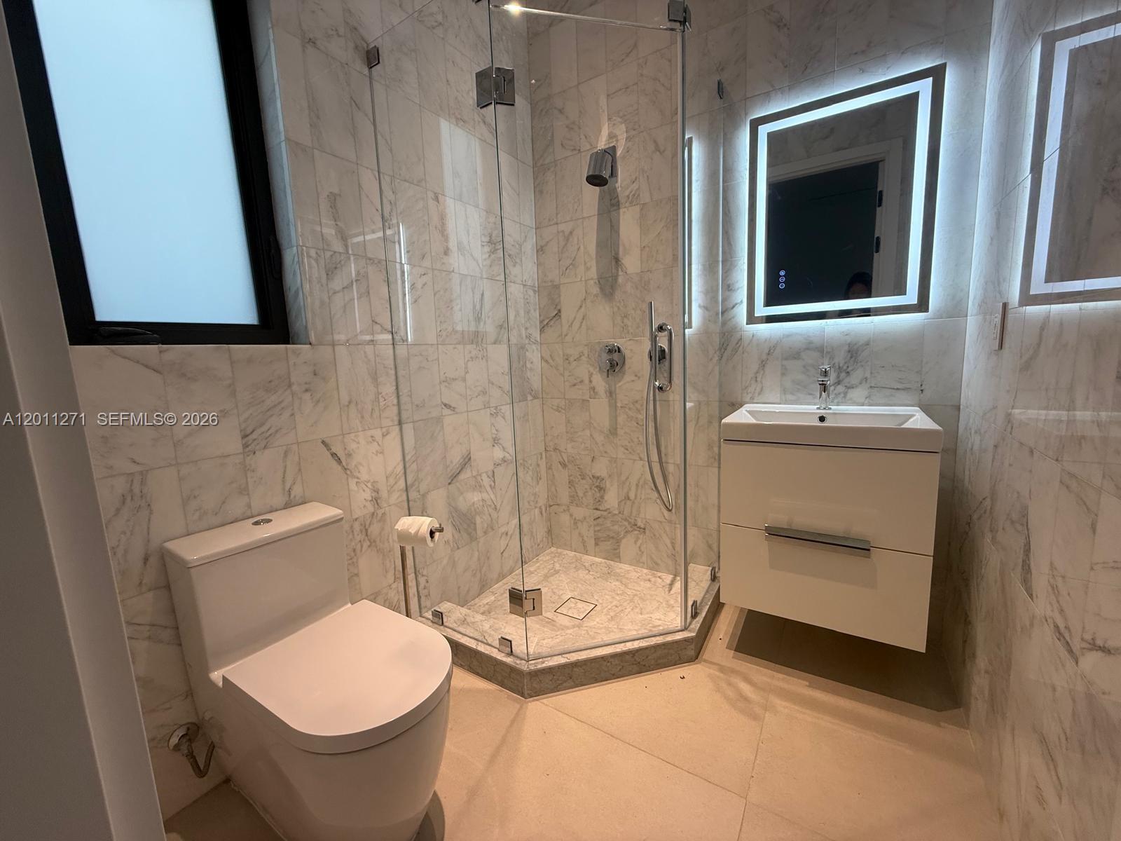 125 Southwest 29th Road Miami, FL 33129 - Photo 41 of 45 a bathroom with a sink and mirror with toilet