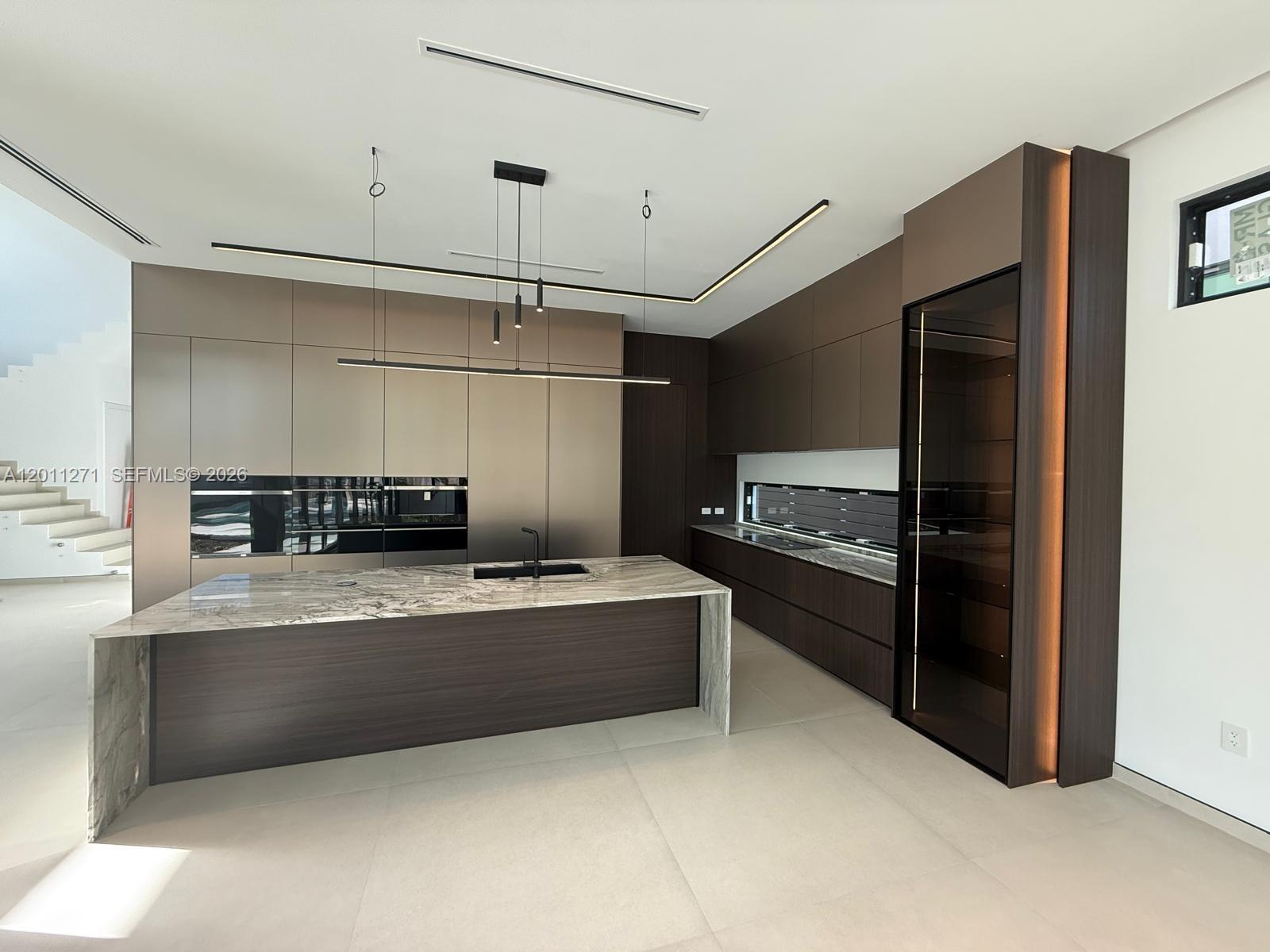125 Southwest 29th Road Miami, FL 33129 - Photo 6 of 45 a large kitchen with stainless steel appliances and a refrigerator