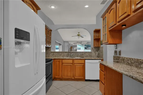 en empty room with wooden floor and windows