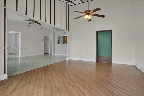 an empty room with windows and cabinet